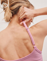 pink waist length tank with adjustable spaghetti straps.